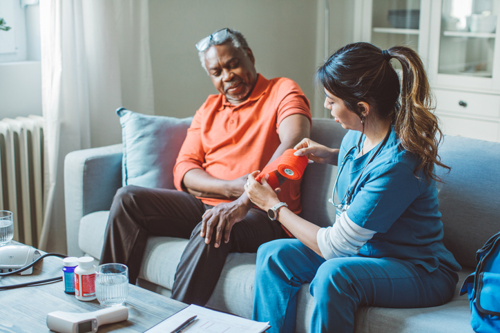 Caregiver helping patient with wound care