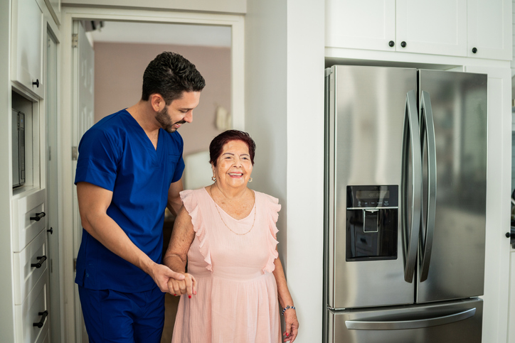 Caregiver helping patient with balance